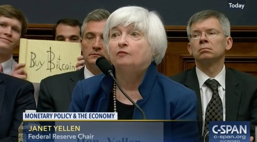 buy-bitcoin-sign-behind-janet-yellen-auction-1-million